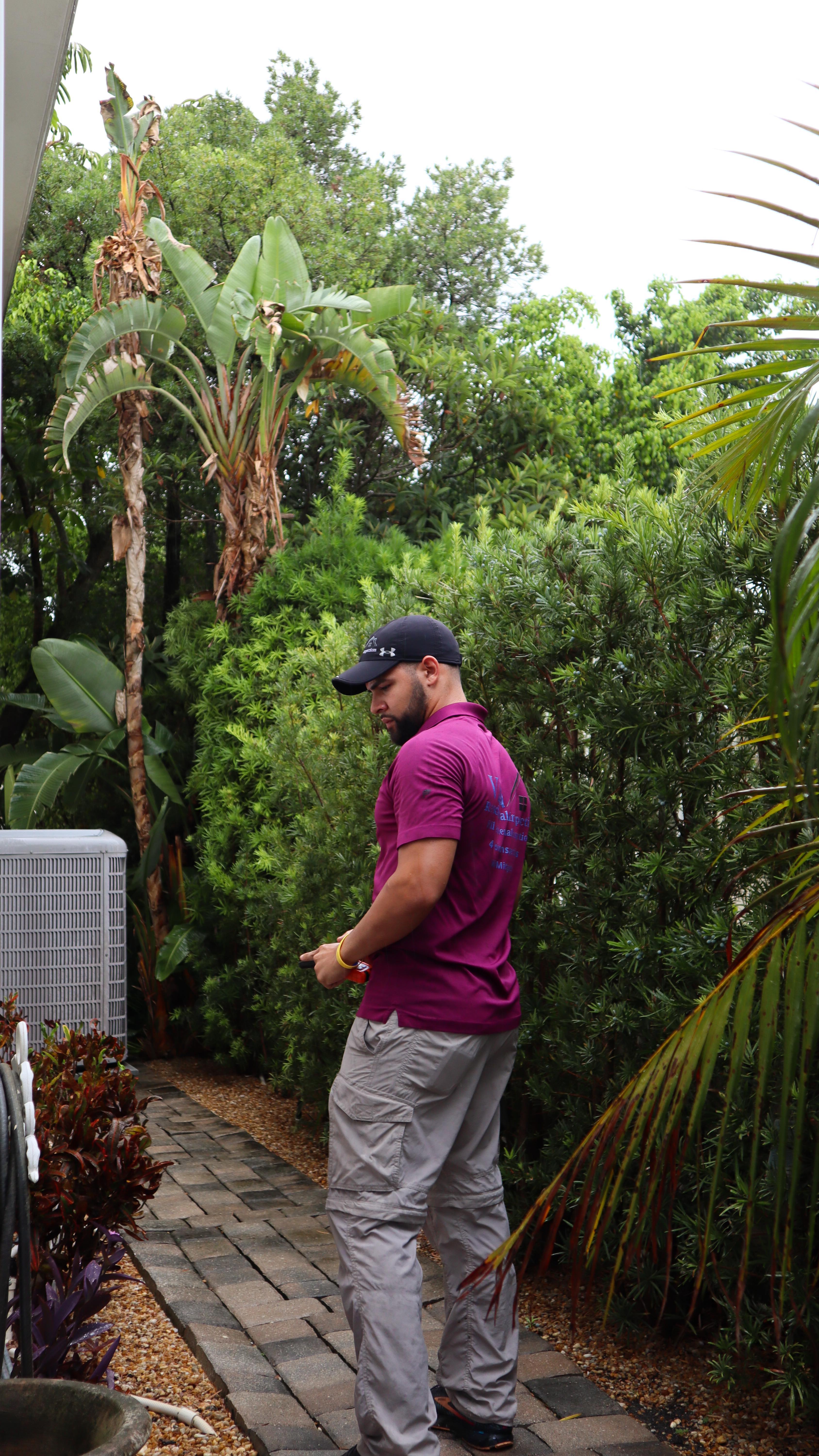 Jelvis Villanueva inspecting outdoor HVAC equipment during a home inspection